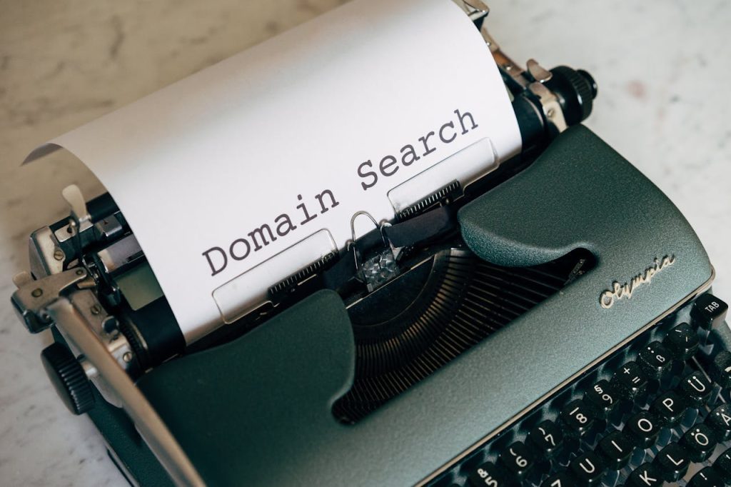 Mastering the First Impression: Your intriguing post title goes here Close-up of a vintage typewriter with paper displaying Domain Search text, ideal for retro themes.